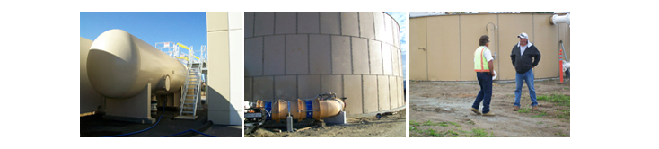 water storage facililties and 2 men standing in front of one water storage facility